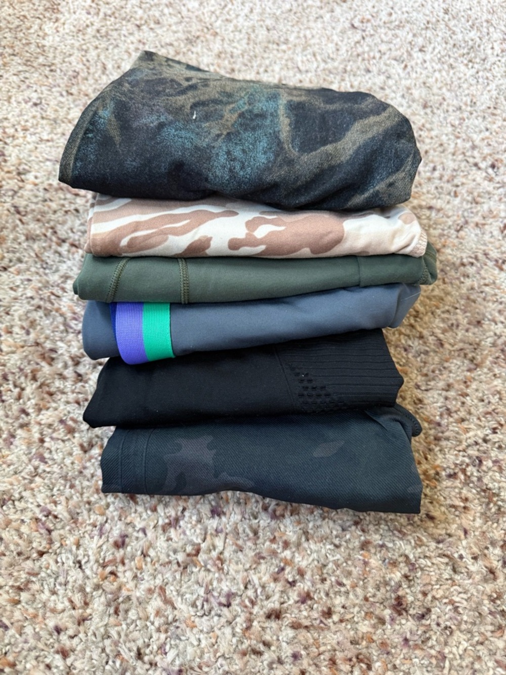 Stack of Women's Athletic Pants in Black, Olive, Gray, Camouflage